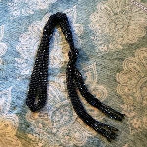 Beaded black beaded lariat necklace.
